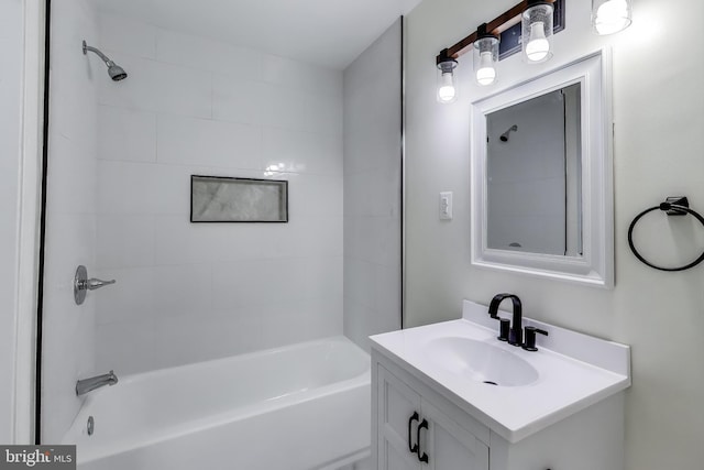 bathroom featuring tiled shower / bath combo and vanity