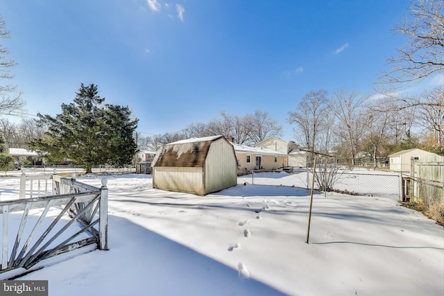 snowy yard with a storage unit