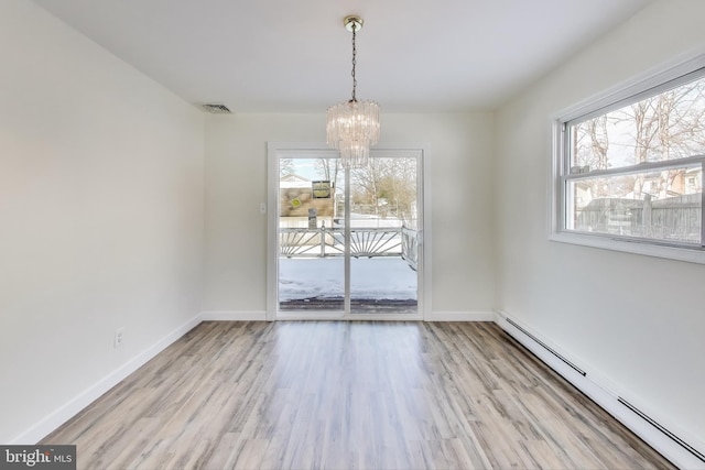 unfurnished dining area with a baseboard radiator, a wealth of natural light, light hardwood / wood-style flooring, and a chandelier