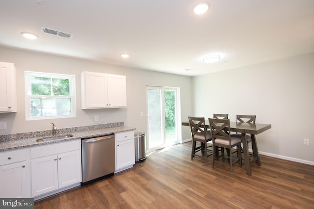 kitchen featuring light stone countertops, dark hardwood / wood-style flooring, white cabinets, stainless steel dishwasher, and sink