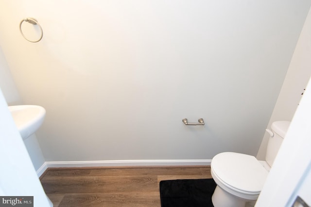 bathroom featuring toilet and hardwood / wood-style flooring