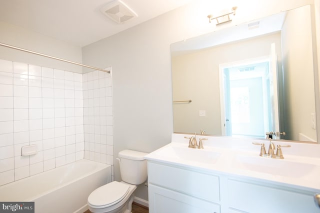 full bathroom featuring toilet, tiled shower / bath combo, and vanity