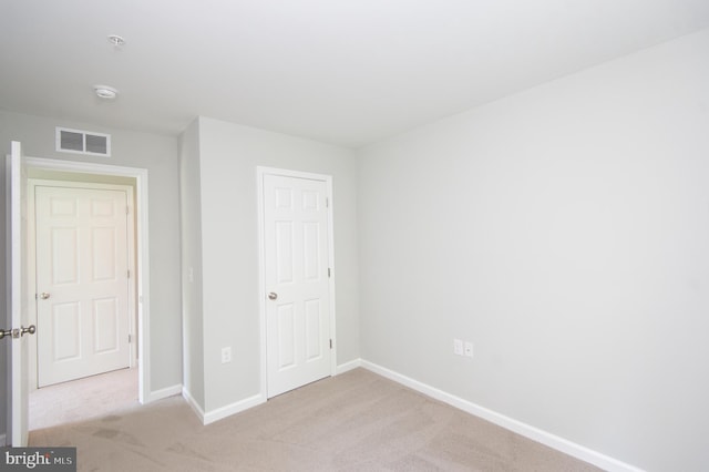 unfurnished bedroom featuring light colored carpet