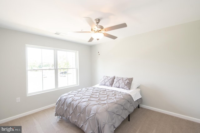 bedroom featuring light colored carpet and ceiling fan