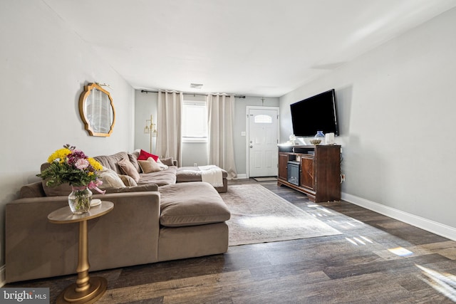 living room with dark hardwood / wood-style flooring