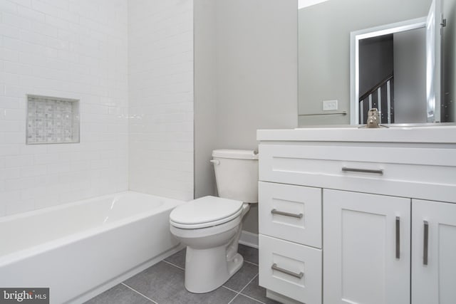 full bathroom with toilet, vanity, tile patterned floors, and washtub / shower combination