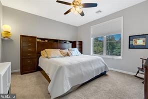 bedroom featuring light colored carpet and ceiling fan