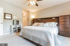 carpeted bedroom featuring ceiling fan