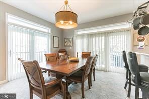 dining area featuring light colored carpet