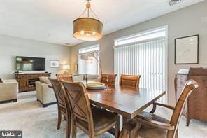 dining space featuring light colored carpet