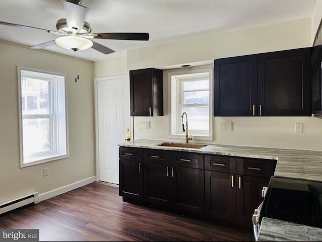 kitchen featuring sink, electric stove, baseboard heating, and a healthy amount of sunlight