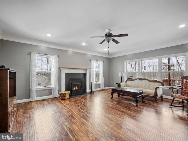 living room with ceiling fan, hardwood / wood-style flooring, crown molding, and a healthy amount of sunlight