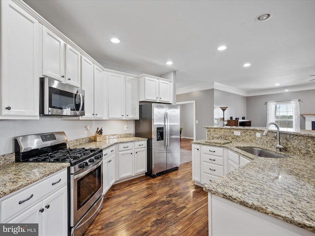 kitchen featuring dark hardwood / wood-style floors, sink, stainless steel appliances, white cabinets, and light stone counters