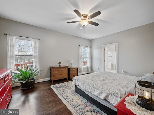 bedroom with ceiling fan, multiple windows, dark hardwood / wood-style floors, and connected bathroom