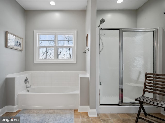 bathroom with plus walk in shower and tile patterned flooring