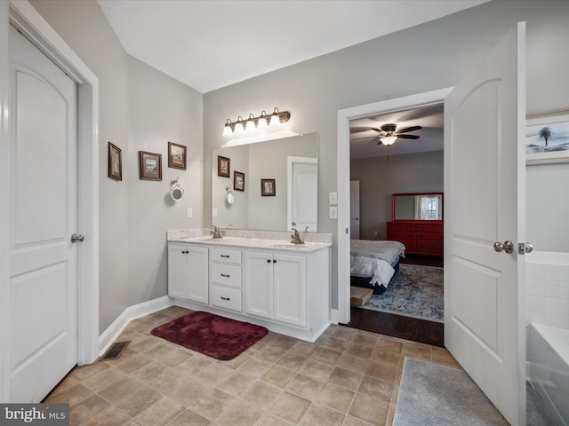 bathroom with ceiling fan, vanity, and a bathing tub