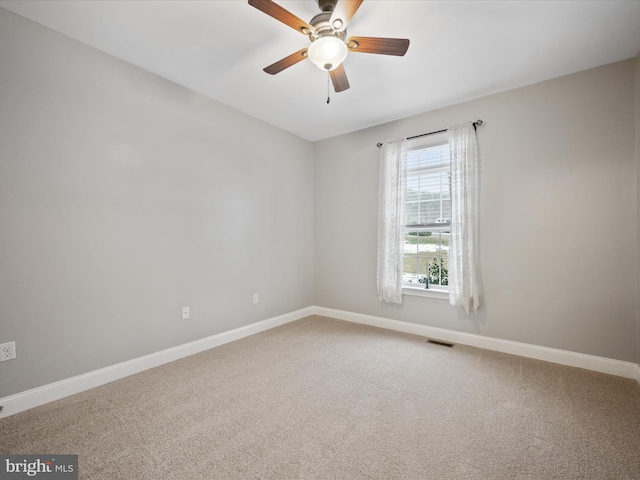 carpeted spare room with ceiling fan