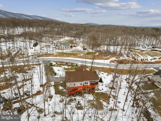 snowy aerial view with a mountain view