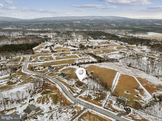 snowy aerial view with a mountain view