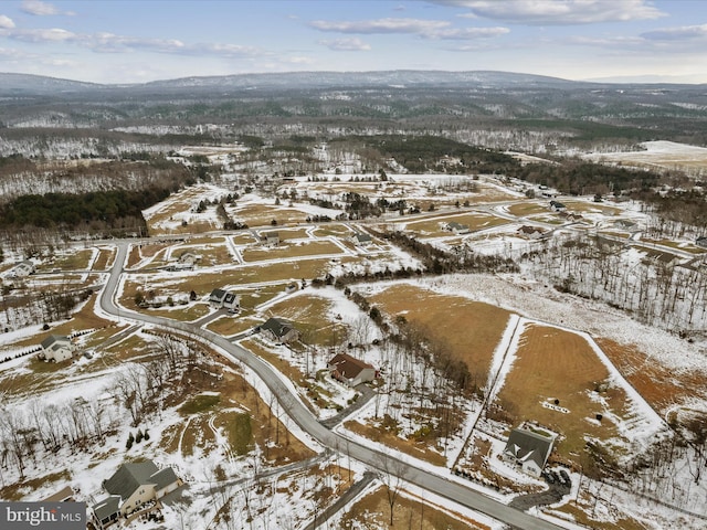 snowy aerial view with a mountain view