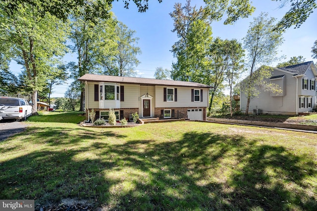 split foyer home featuring a front lawn and a garage