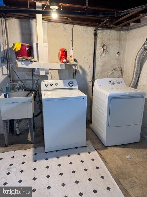 washroom featuring washing machine and clothes dryer and sink