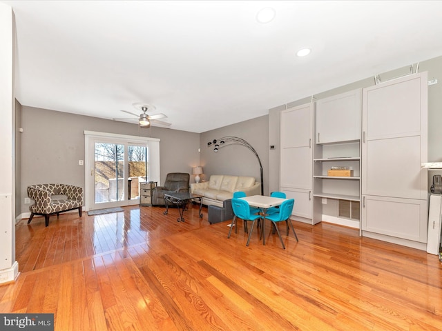 sitting room featuring ceiling fan and light wood-type flooring