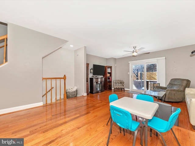 dining space with light hardwood / wood-style floors and ceiling fan