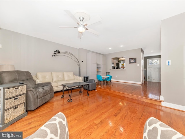 living room with ceiling fan and wood-type flooring