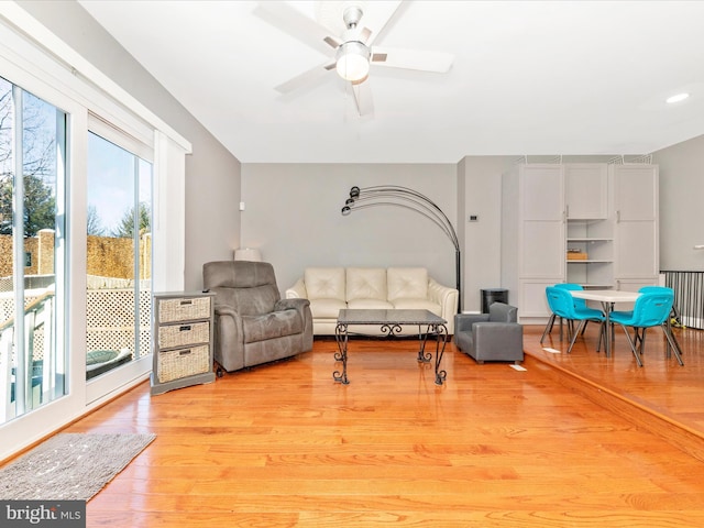 living room featuring ceiling fan and light wood-type flooring