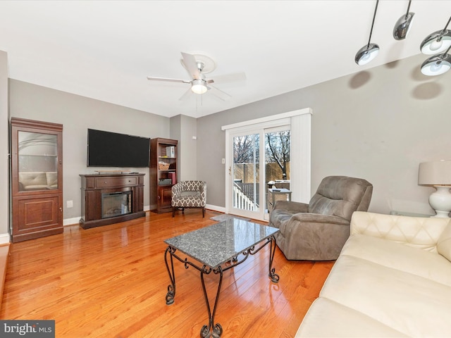 living room featuring hardwood / wood-style floors and ceiling fan