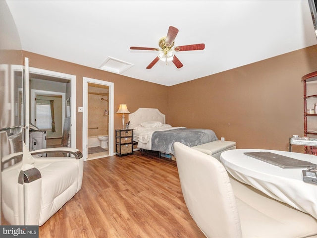 bedroom with light hardwood / wood-style flooring, ceiling fan, and ensuite bathroom