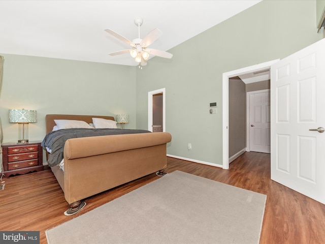 bedroom with wood-type flooring, vaulted ceiling, and ceiling fan