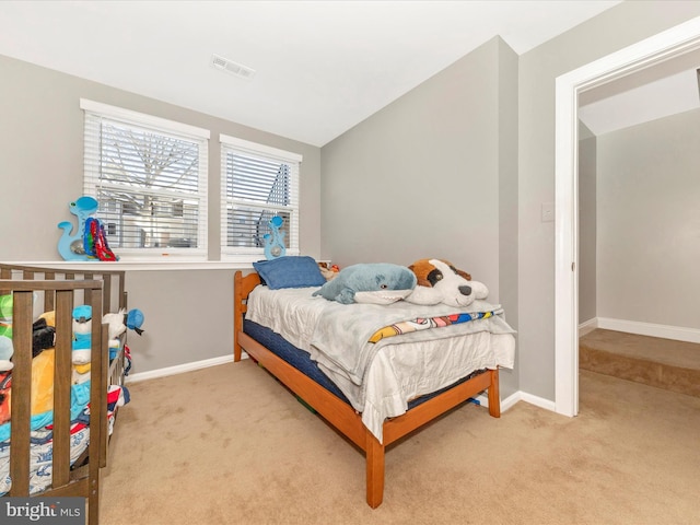 bedroom featuring vaulted ceiling and light colored carpet