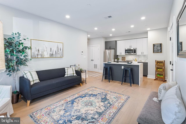 living room with light hardwood / wood-style flooring