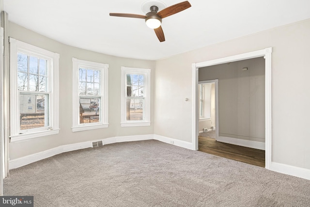 carpeted empty room with ceiling fan