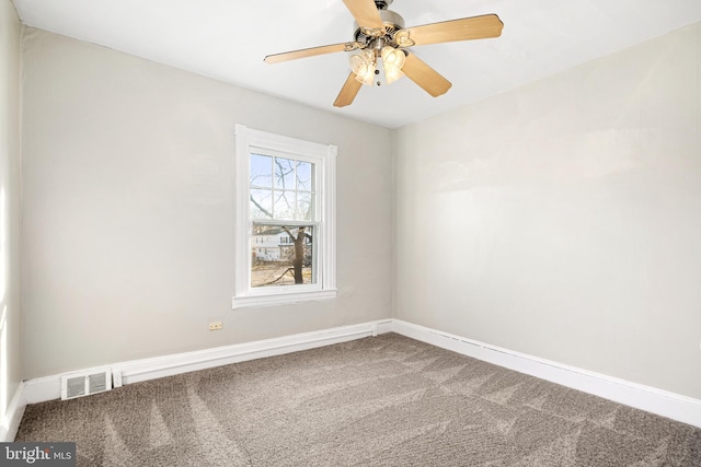 carpeted spare room featuring ceiling fan