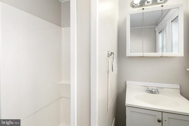 bathroom with walk in shower and vanity