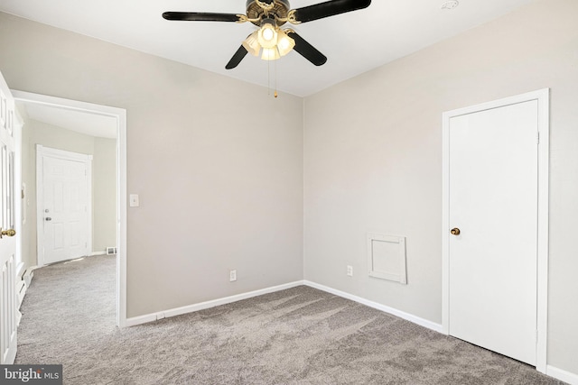 empty room featuring light colored carpet and ceiling fan