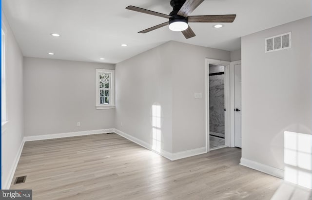 spare room featuring light hardwood / wood-style floors and ceiling fan