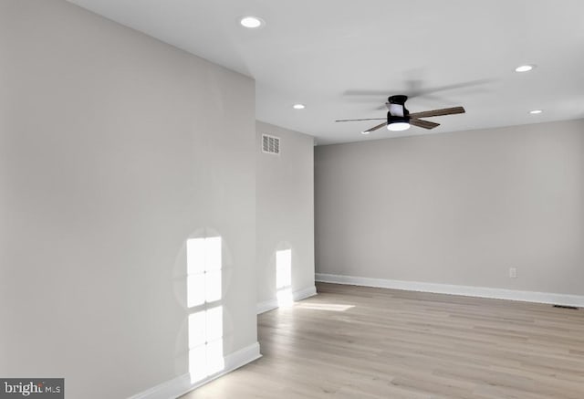 empty room featuring light wood-type flooring and ceiling fan