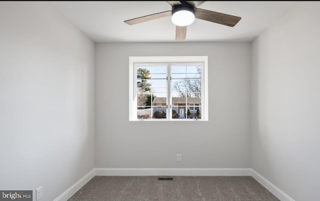 unfurnished room with ceiling fan and carpet