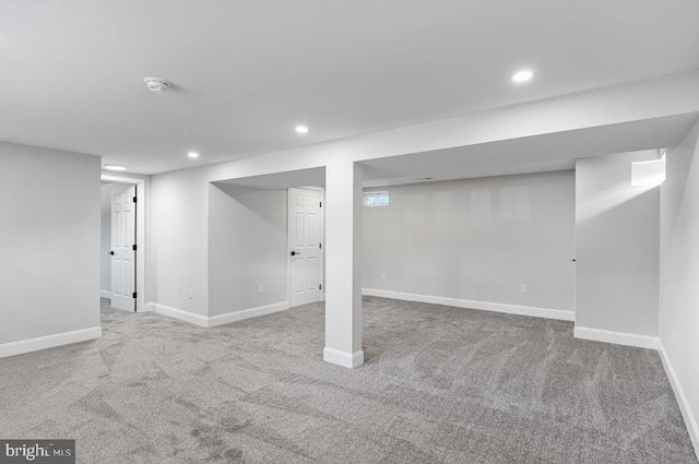 basement featuring light carpet