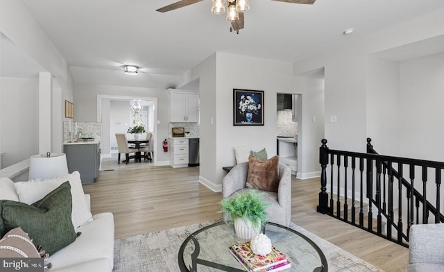 living room with light wood-type flooring and ceiling fan