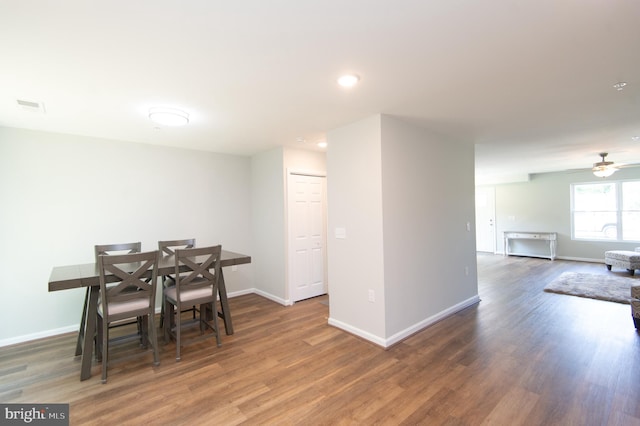 dining area with ceiling fan and dark hardwood / wood-style floors