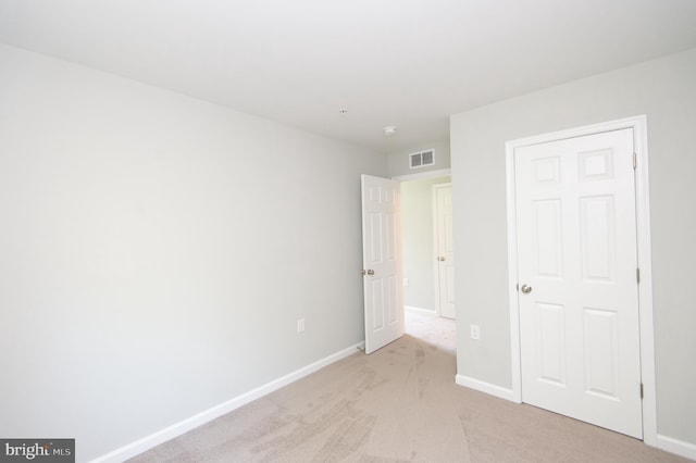 unfurnished bedroom featuring light colored carpet