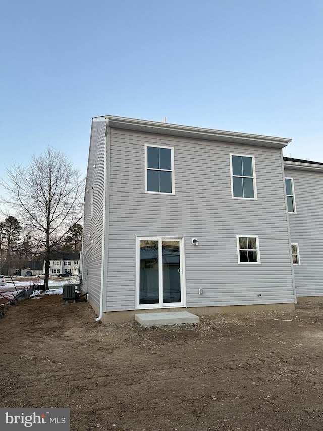 rear view of property with central AC unit