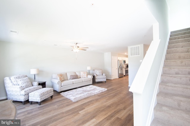 living room with hardwood / wood-style floors and ceiling fan