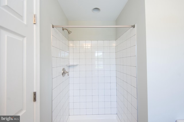 bathroom with tiled shower