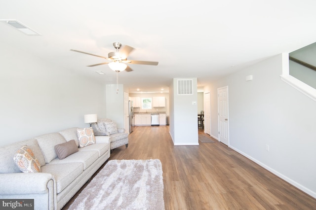 living room featuring ceiling fan and hardwood / wood-style floors